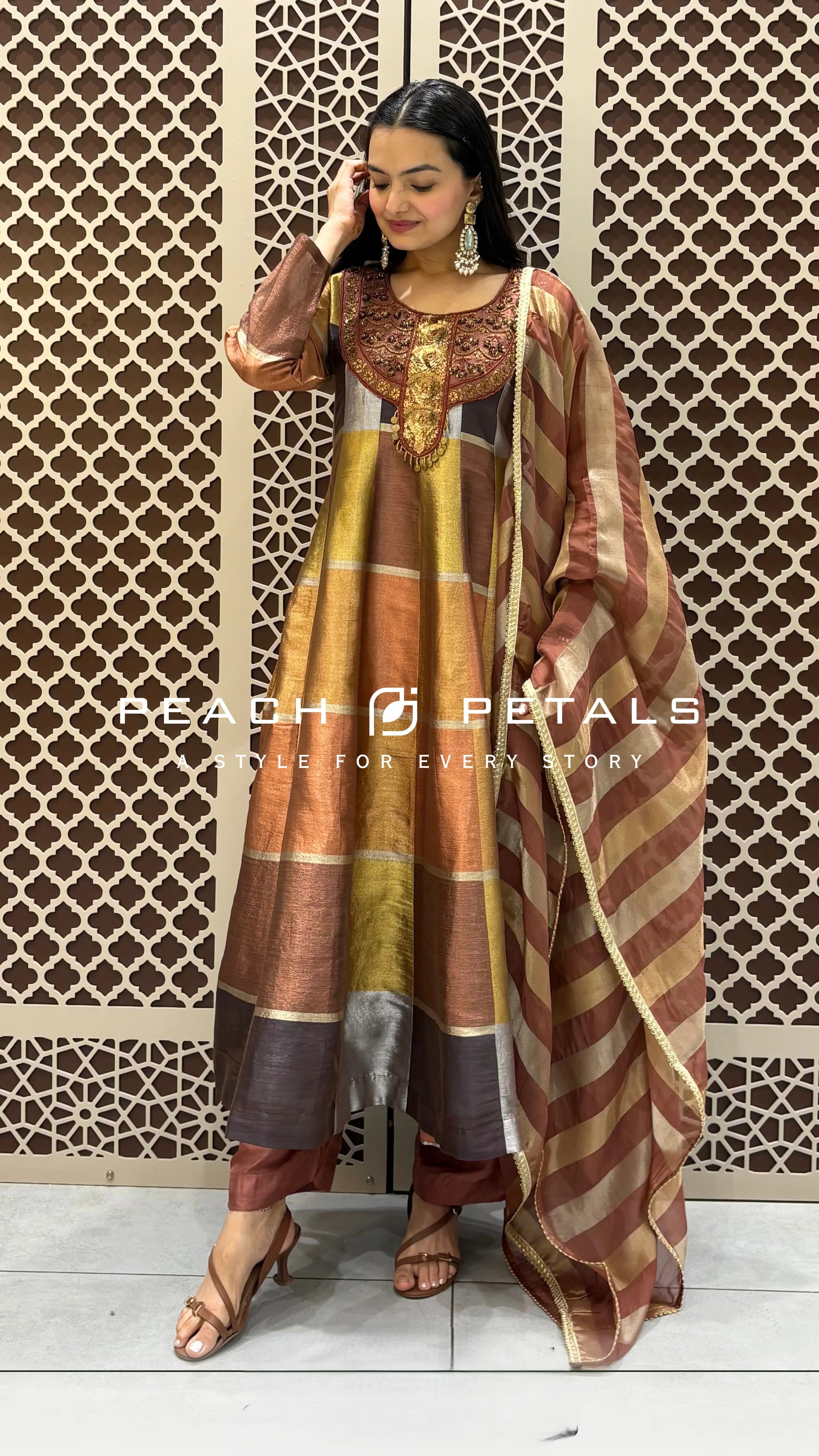 Silk checkered Anarkali suit featuring heavy gold neck embroidery, striped dupatta, and matching trousers.