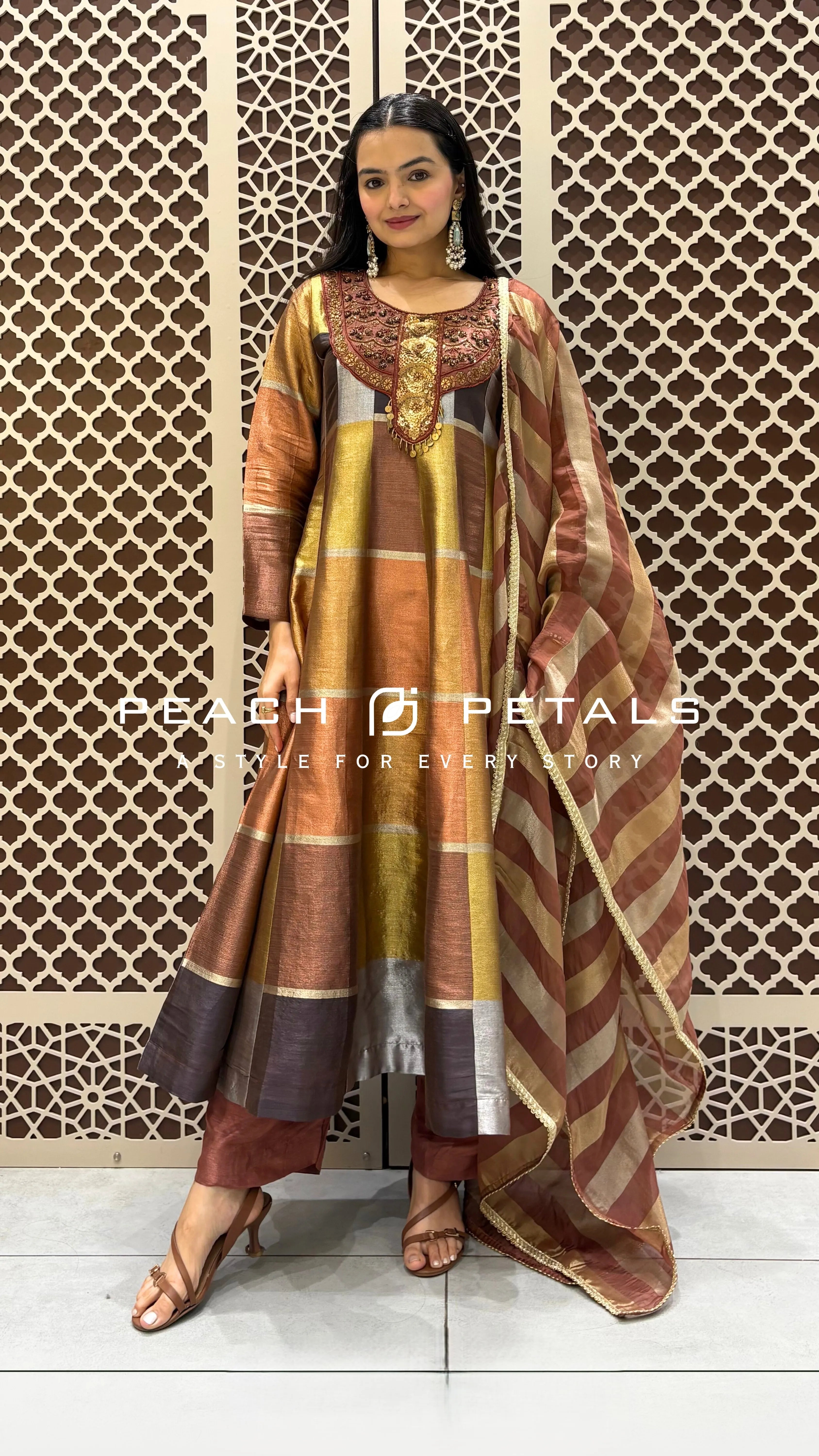 Silk checkered Anarkali suit featuring heavy neck embroidery, paired with a striped dupatta and trousers.
