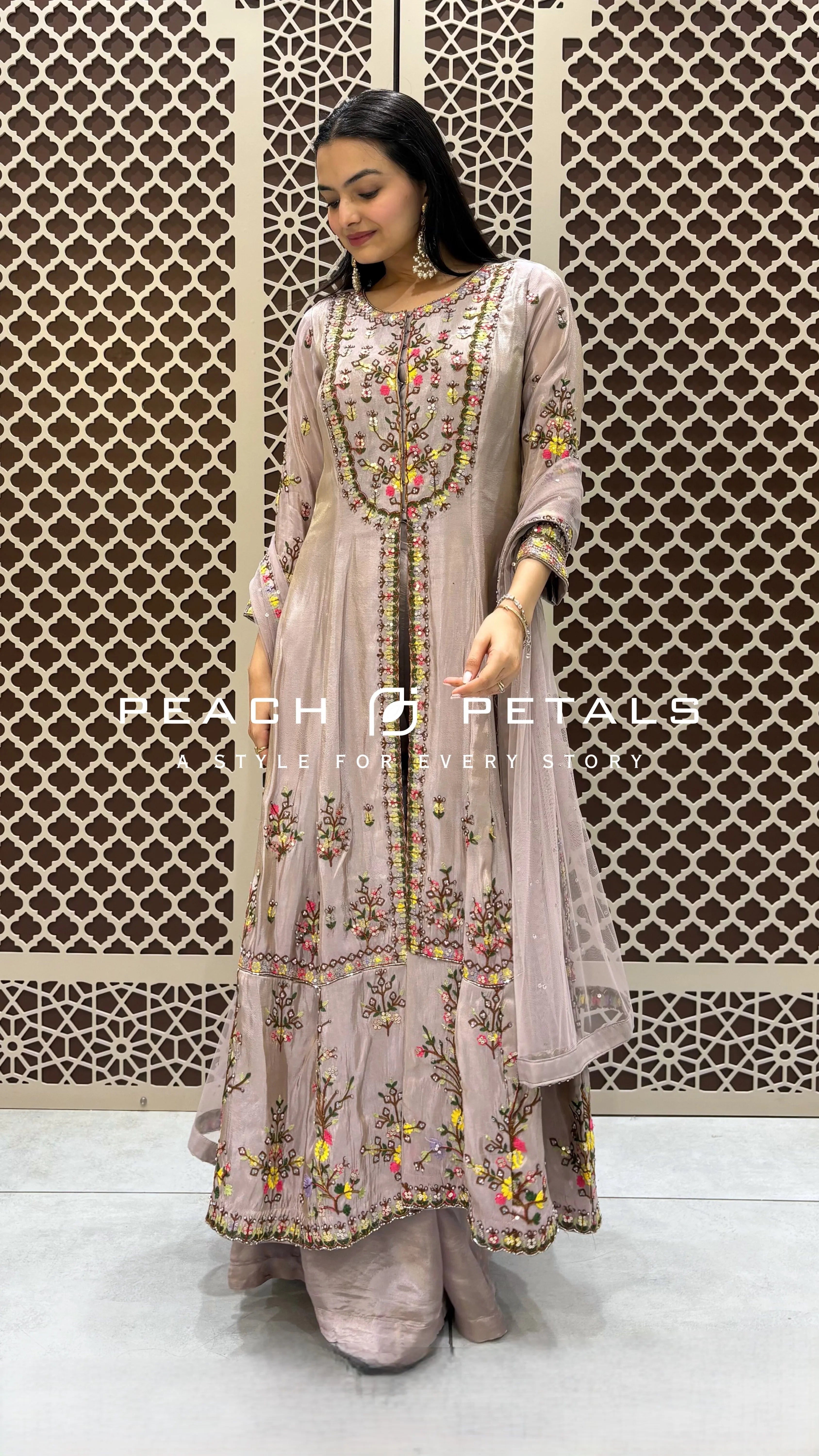 Dusty mauve longline front-slit kurta with colorful floral embroidery paired with matching silk parallel pants.