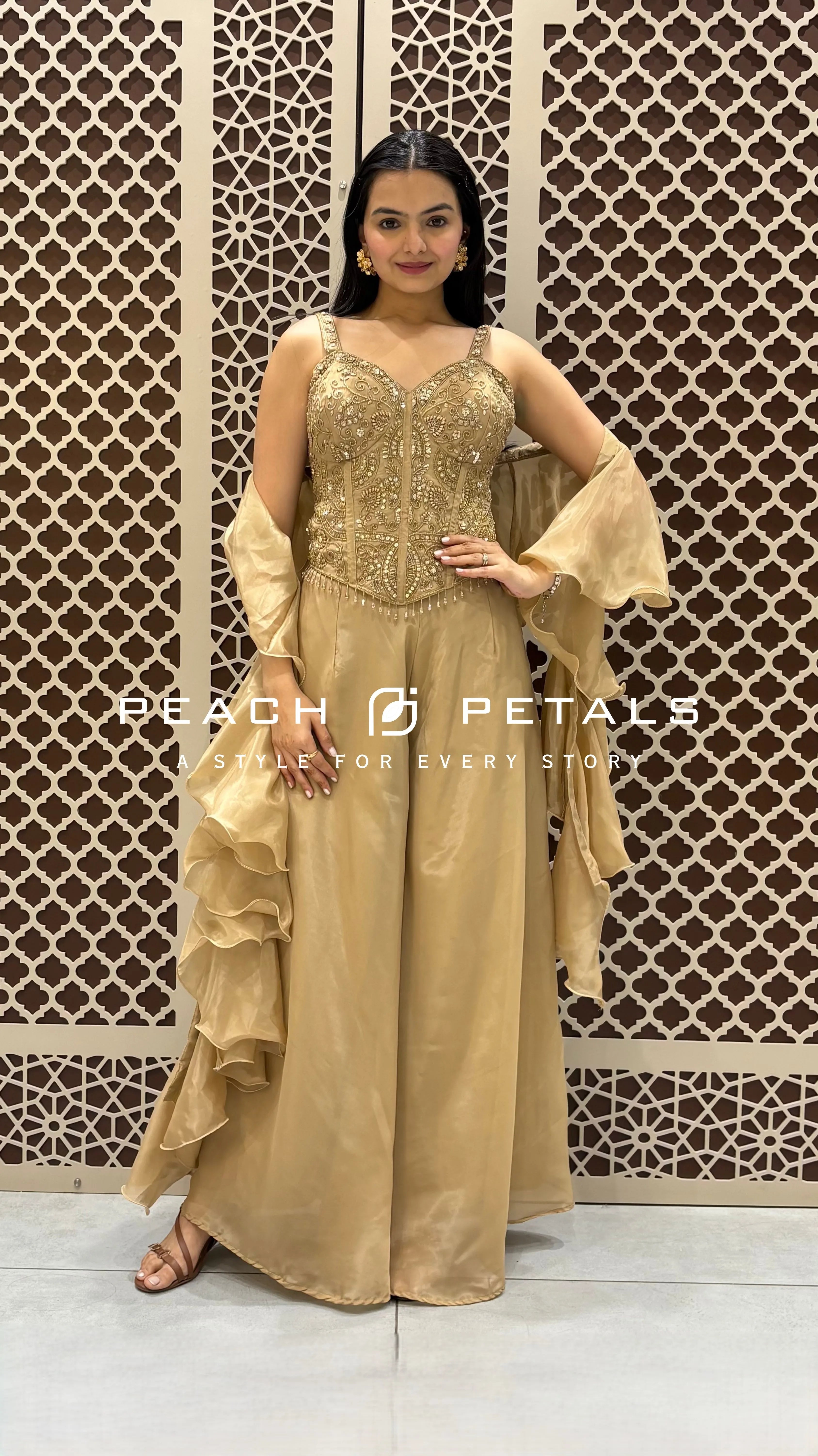 Metallic gold ethnic set featuring a heavily embroidered corset top, wide-leg palazzos, and ruffled dupatta.