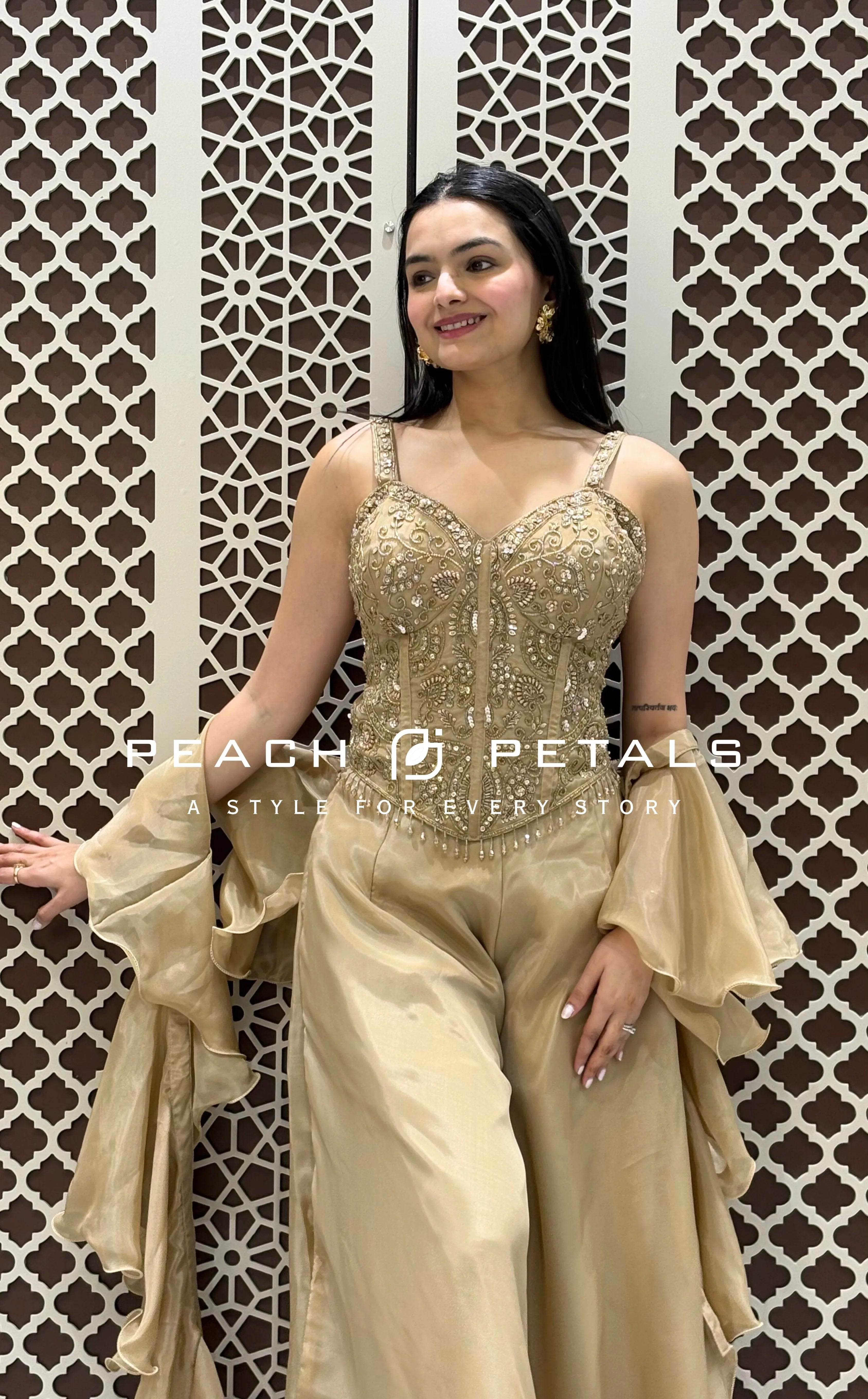 Metallic gold ethnic set featuring a heavily embroidered corset top, wide-leg palazzos, and ruffled dupatta.