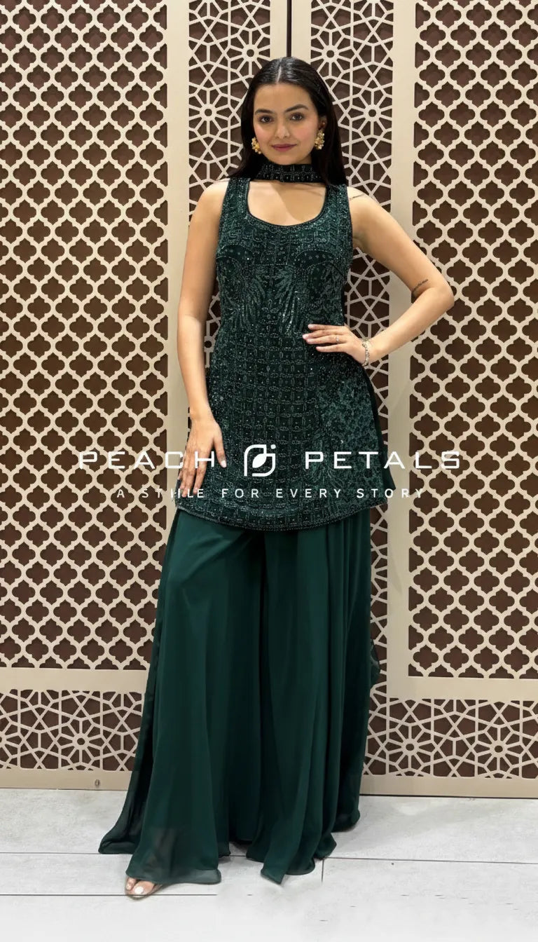 Bottle green sleeveless short kurta with heavy tonal sequin embroidery paired with matching flared sharara pants.