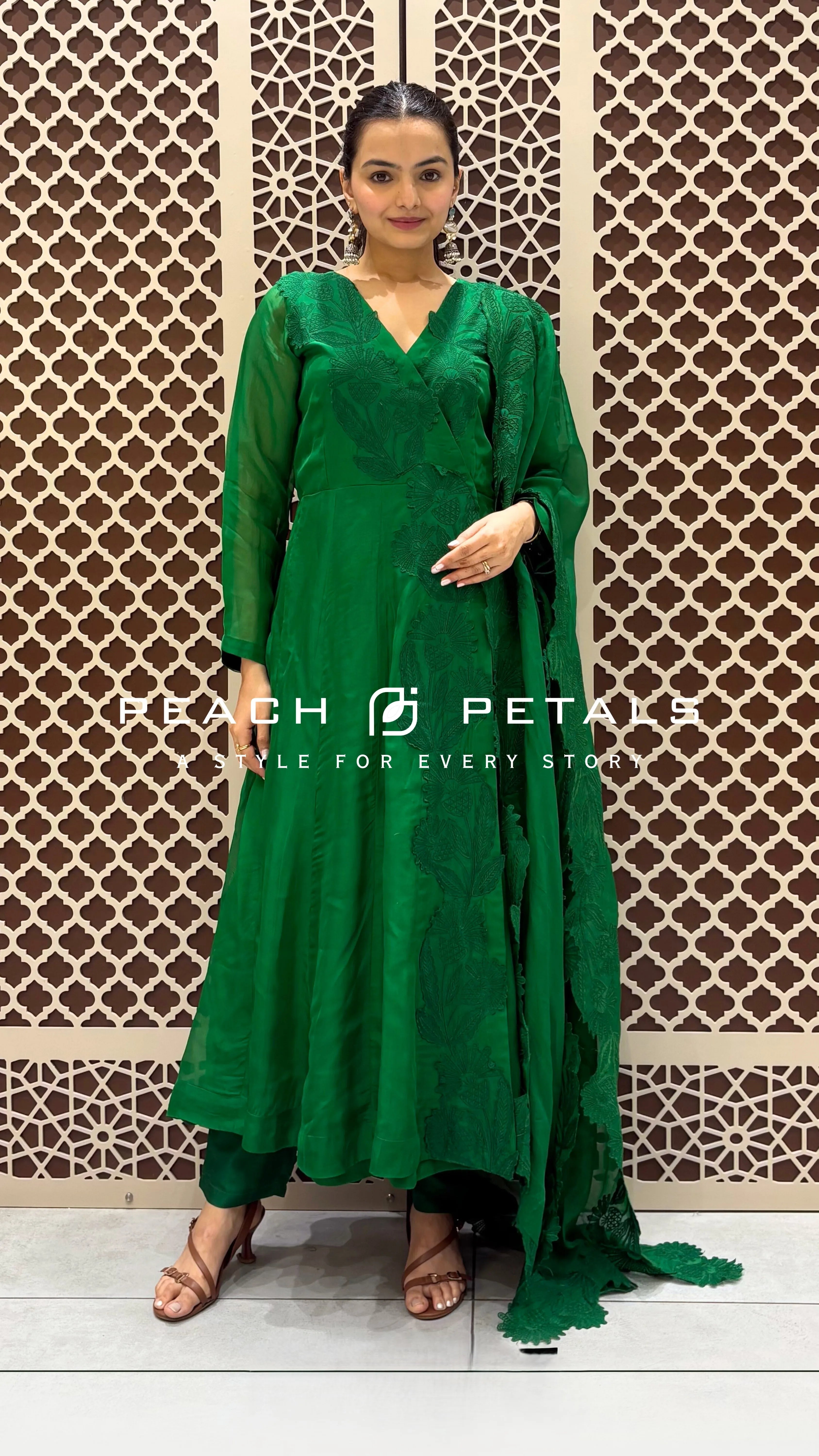 Vibrant green silk Anarkali suit featuring delicate tonal floral embroidery and a matching scalloped edge dupatta.