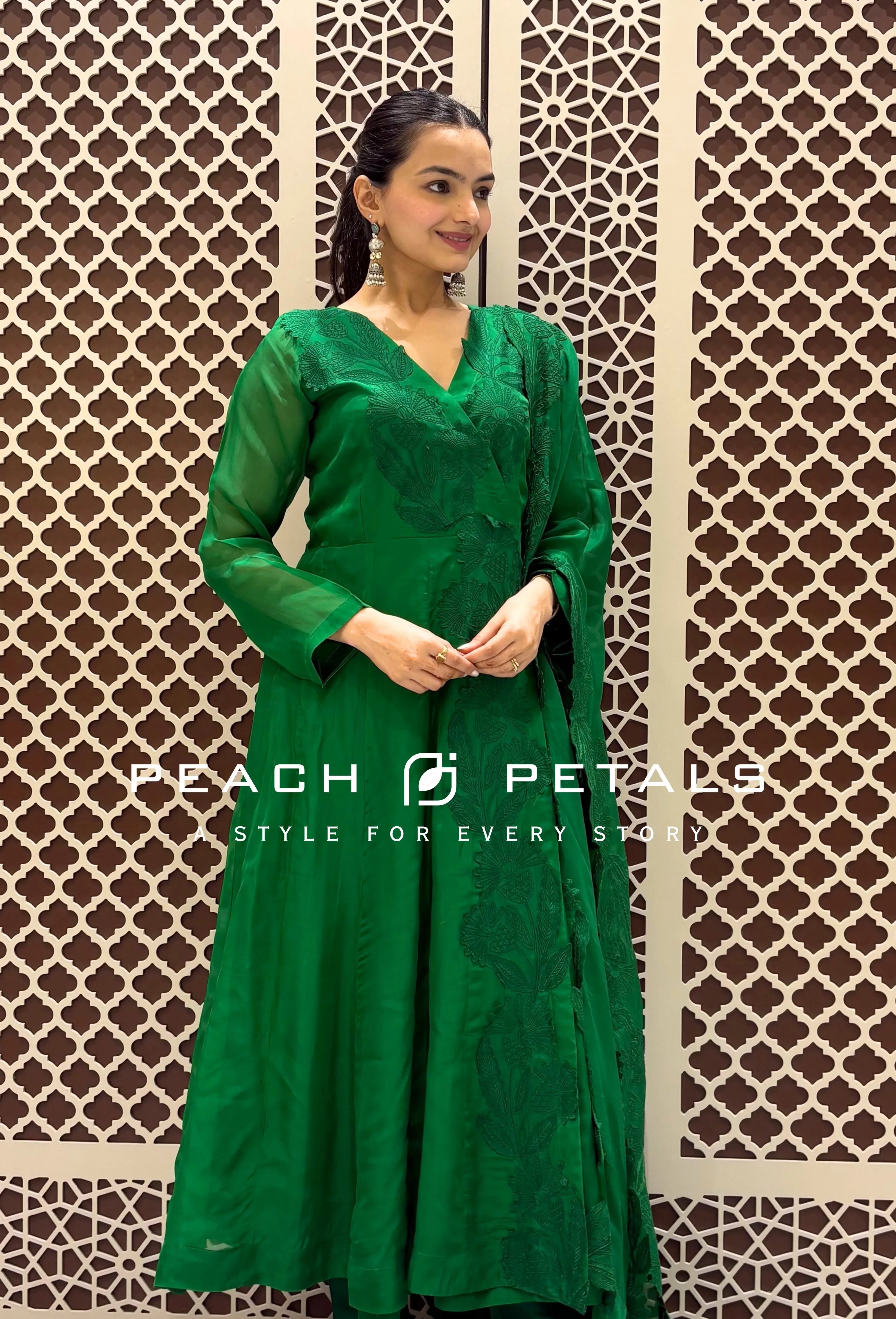 Vibrant green silk Anarkali suit featuring tonal floral embroidery and a matching heavily embroidered scalloped dupatta.