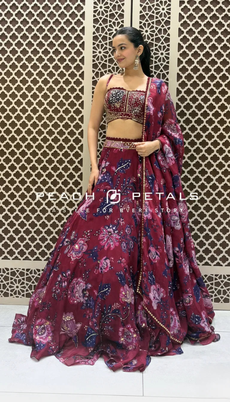 Maroon floral print lehenga set featuring a strappy sequin-embellished bustier top and matching organza dupatta.