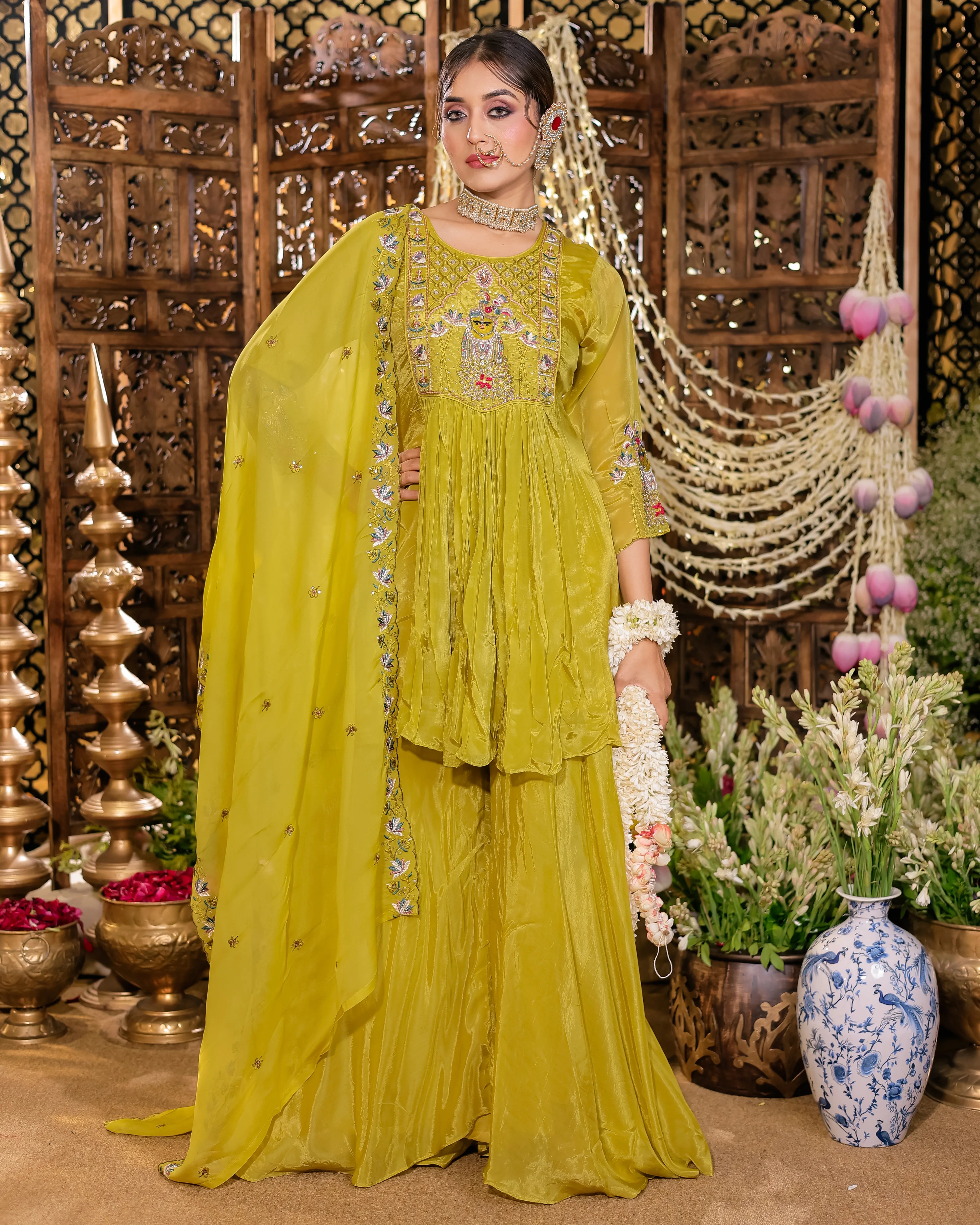 Lime green ethnic tunic featuring elaborate colorful embroidery, paired with a matching dupatta and trousers.