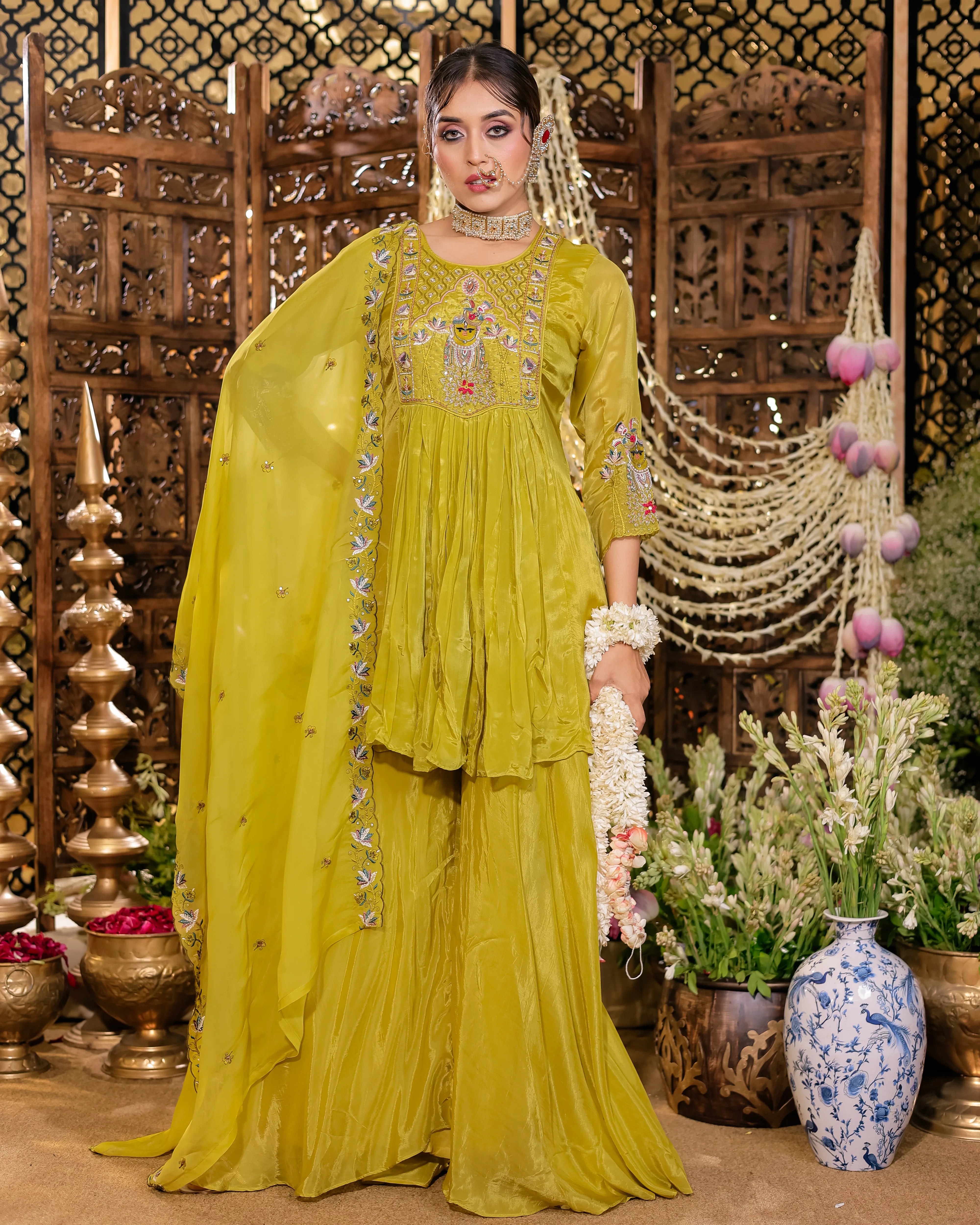 Lime green ethnic suit with intricate chest embroidery and matching sheer dupatta.