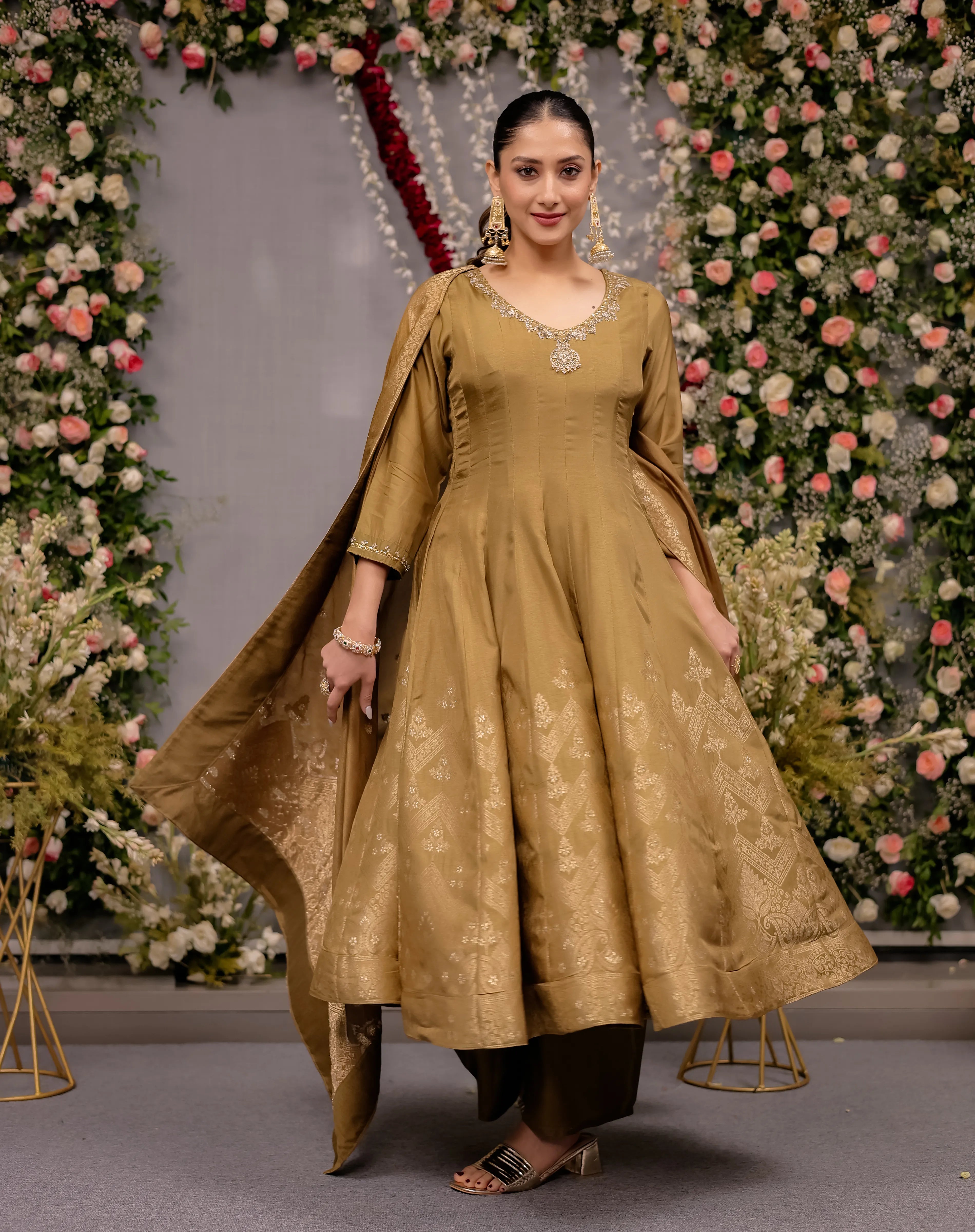 Elegant mustard gold silk Anarkali suit featuring a subtle V-neckline and traditional geometric patterned borders.