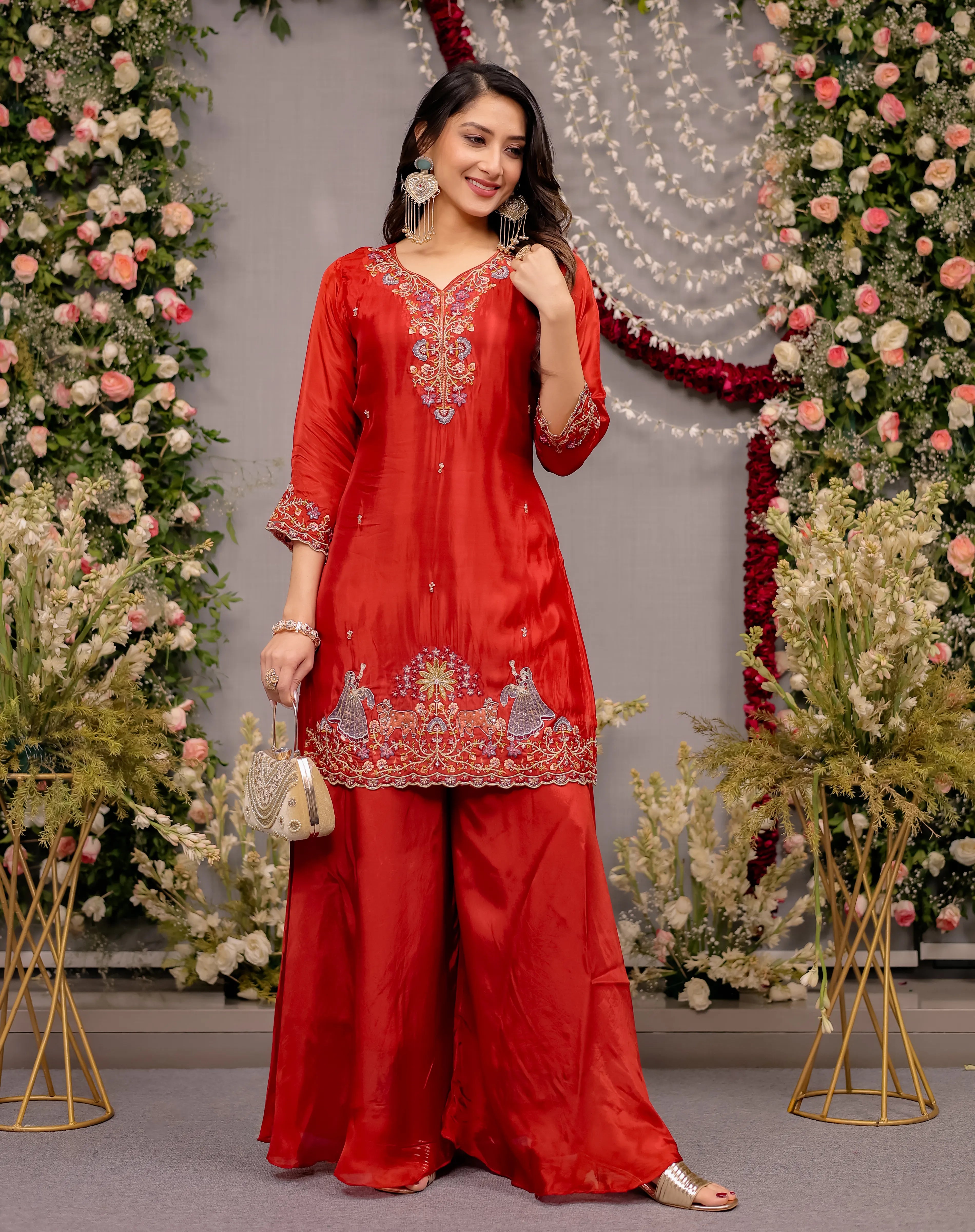 Woman in a red traditional outfit with floral decorations in the background