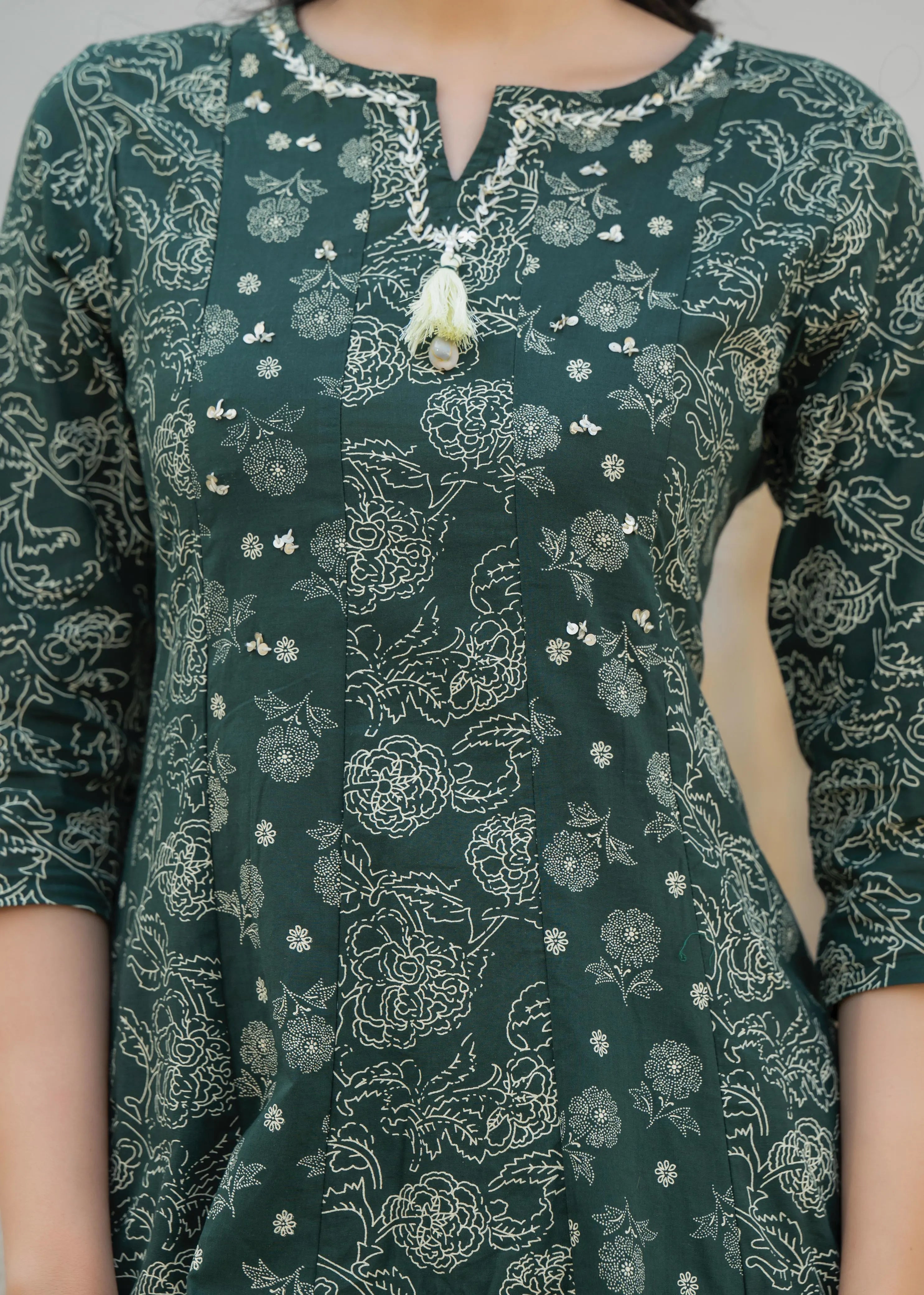 Green floral patterned kurta with white details on a person