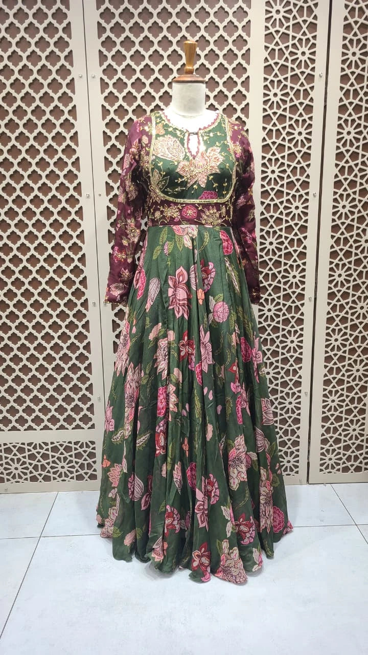 Floral dress on a mannequin against a decorative wall.