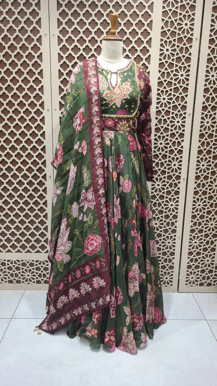 Floral patterned dress on a mannequin against an ornate wall.