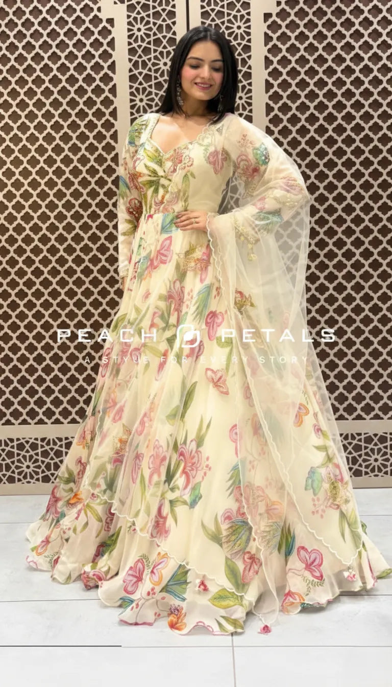Cream floor-length Indo-Western gown with vibrant pastel floral prints and a matching sheer scalloped dupatta.