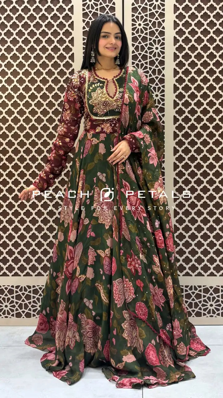 Dark green floor-length flared Anarkali featuring pink floral prints, long sleeves, and an embroidered sequin bodice.