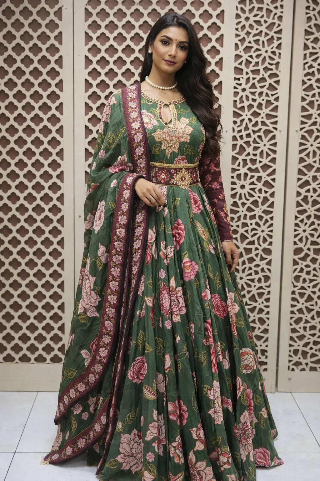 Dark green floor-length flared Anarkali with pink floral prints, maroon embroidered sleeves, and a matching dupatta.