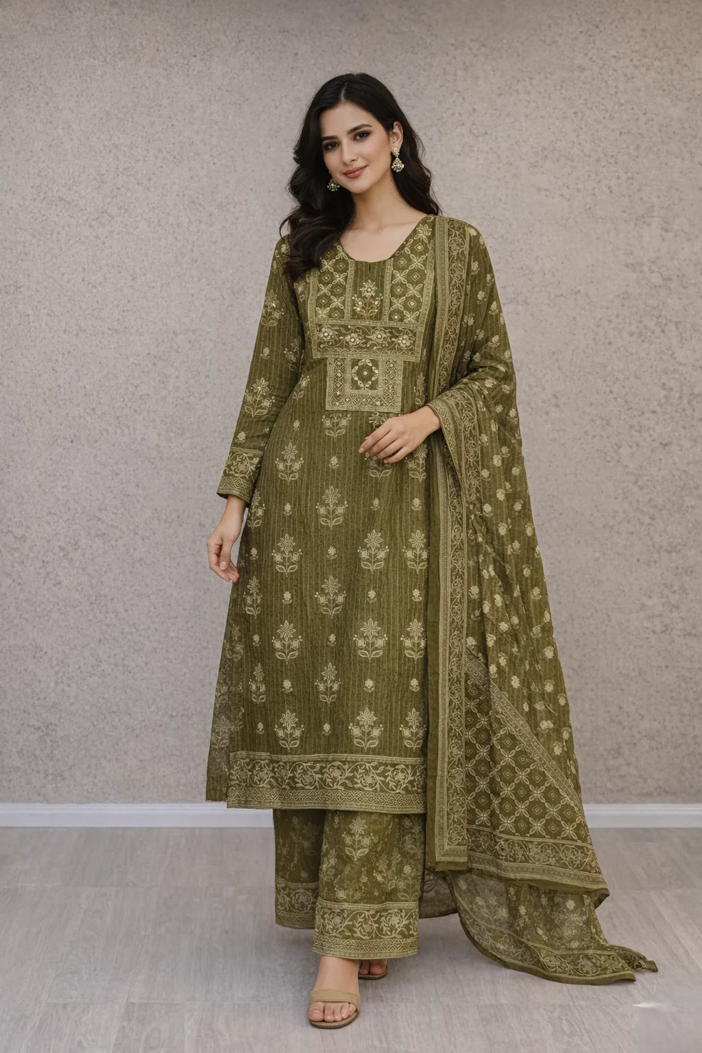 Woman wearing an olive green printed kurta with matching wide-leg trousers and a sheer dupatta.