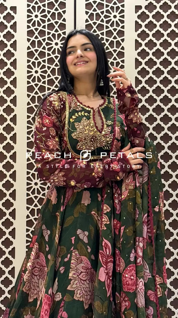 Floor-length dark green flared Anarkali featuring pink floral prints, sequin bodice embroidery, and long sleeves.