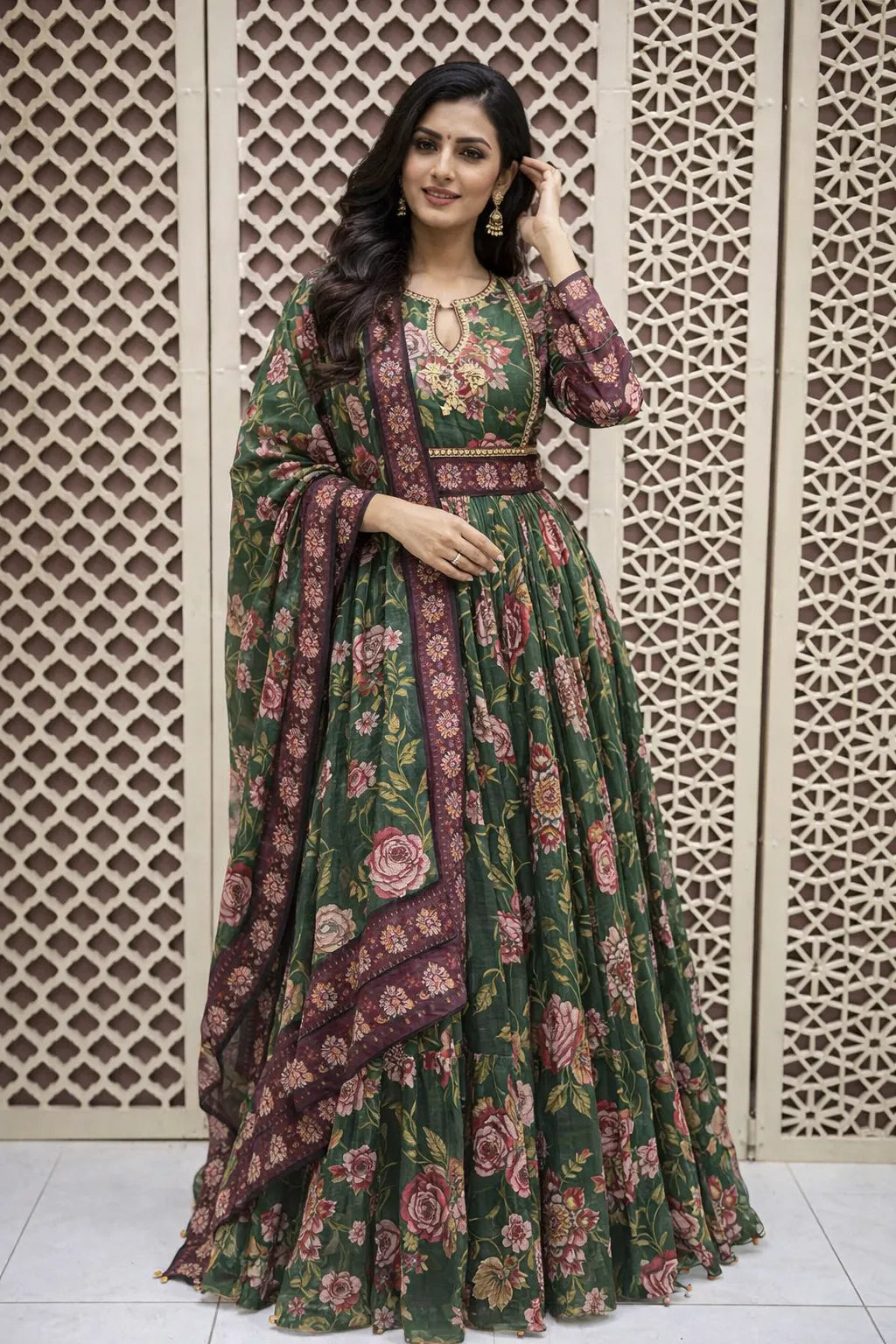 Floor-length dark green flared Anarkali featuring pink floral prints, sequin bodice embroidery, and long sleeves.
