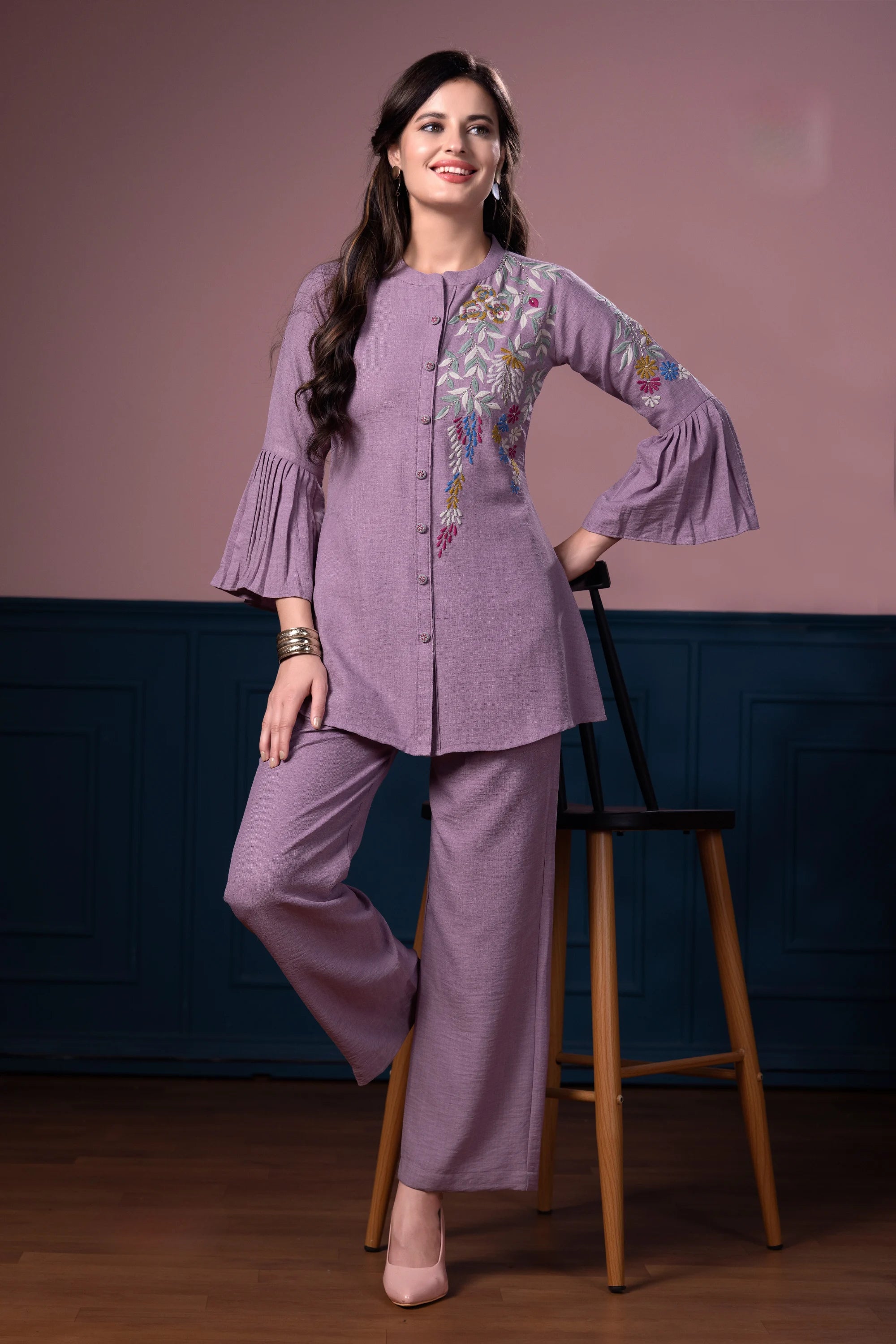 Lavender tunic featuring floral embroidery and bell sleeves, paired with matching wide-leg trousers for women.