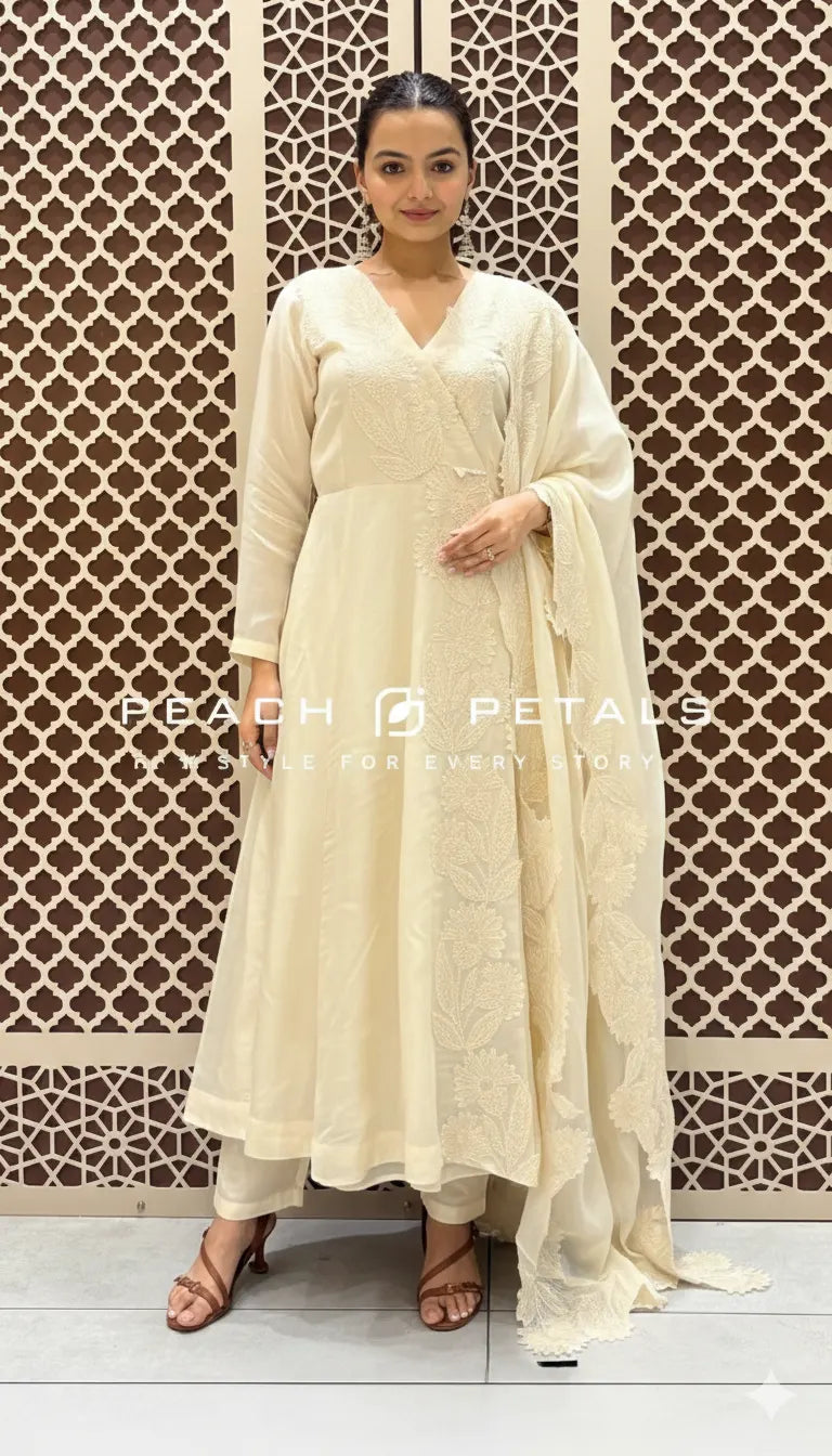 Woman in a white traditional outfit standing against a decorative lattice background with 'Peach Petals' branding.
