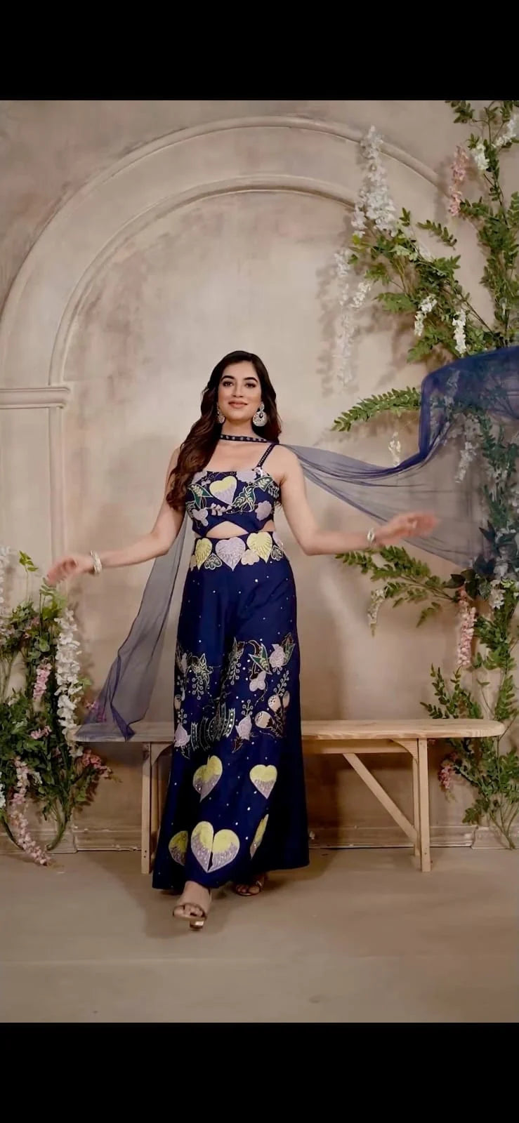 Navy blue sleeveless outfit featuring large heart motifs and a midriff cut-out with a sheer dupatta.