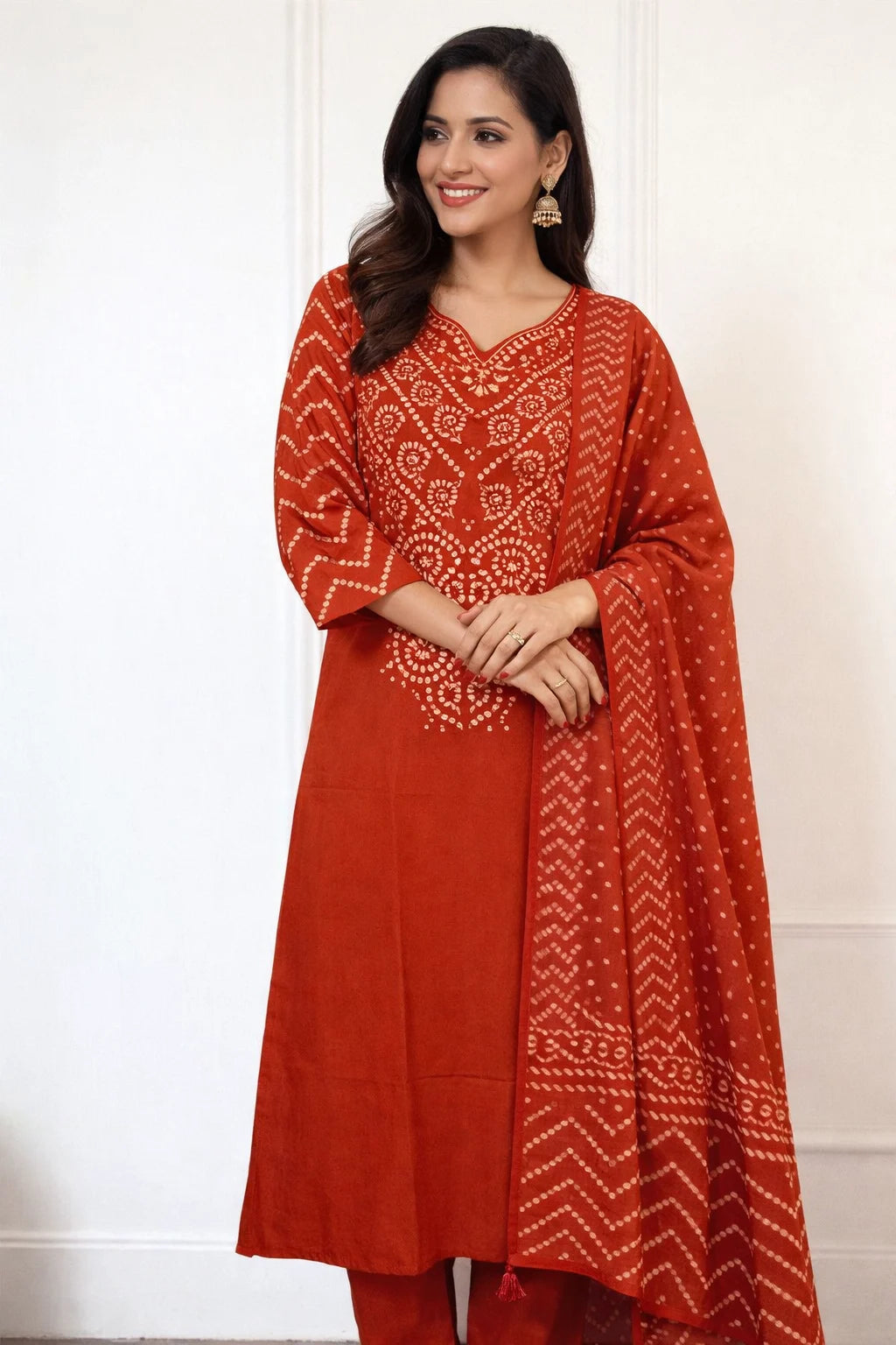 Woman wearing a red traditional outfit with white patterns on a white background