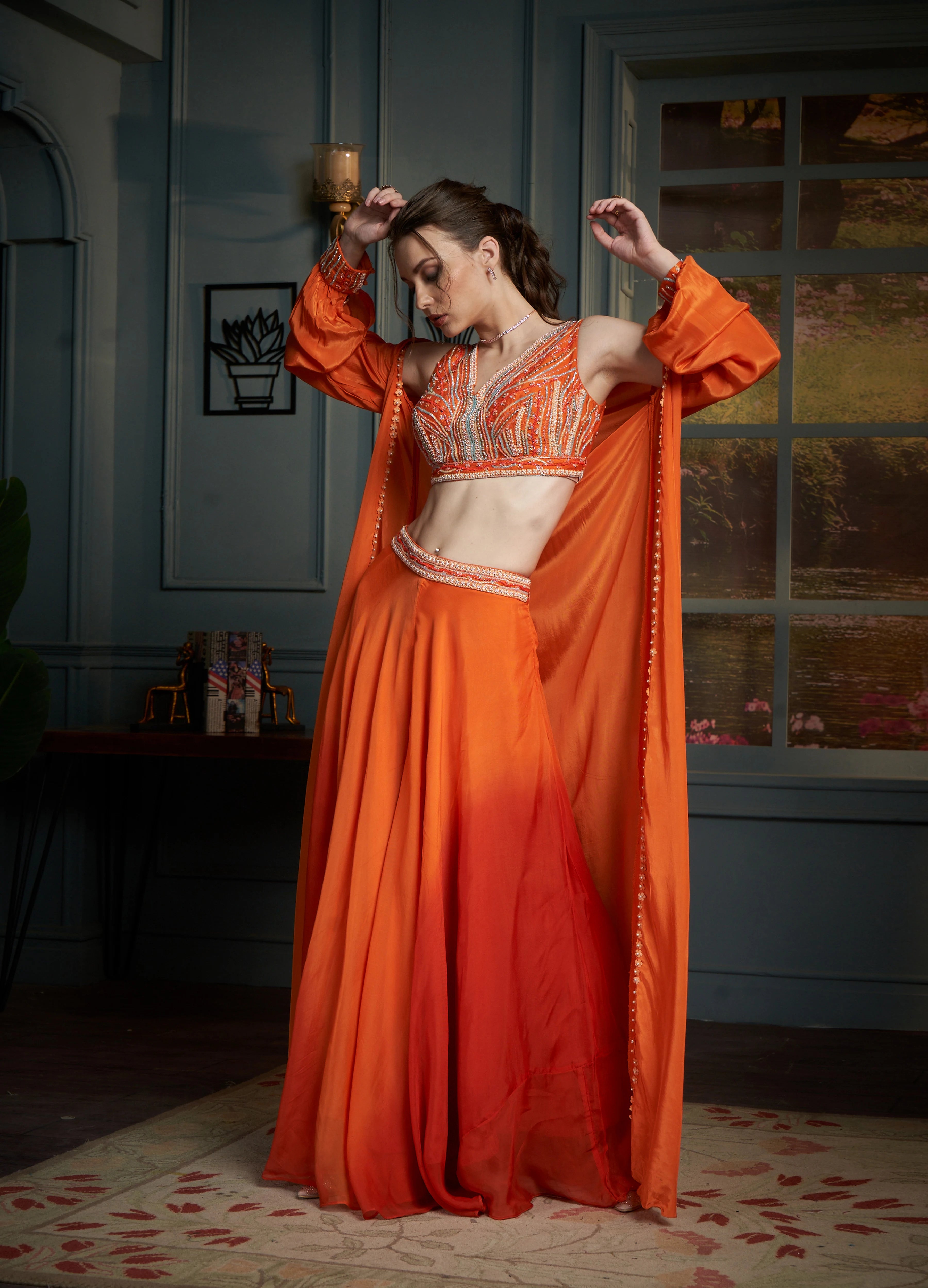 Vibrant orange ensemble featuring a sequined crop top, floor-length Palazzo Set and a matching long-sleeved sheer shrug.